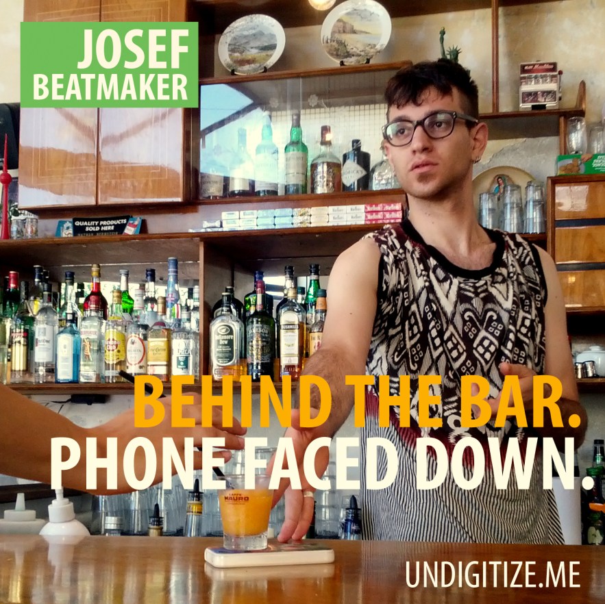 Behind The Bar. Phone Faced Down.
