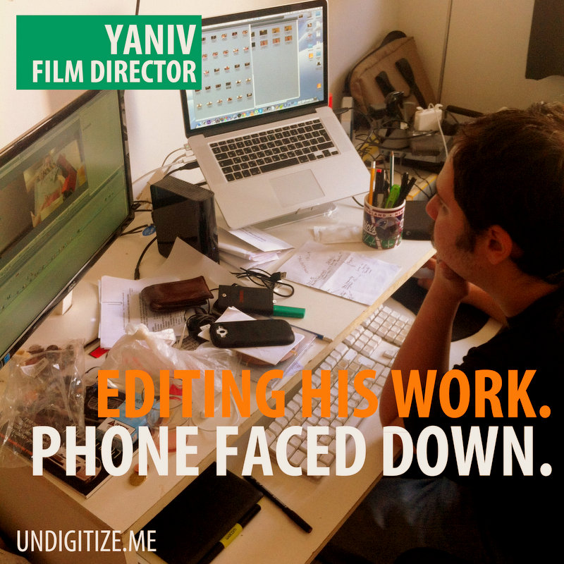 Editing His Work. Phone Faced Down.