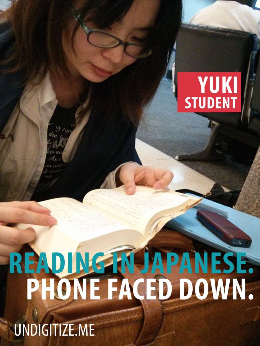 Reading In Japanese. Phone Faced Down.